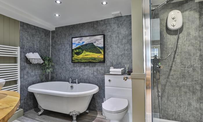 The ensuite in the mini suite has a roll top bath and separate walk in shower, towels, face cloths, make up remover flannel, bath soak, room spray, lu